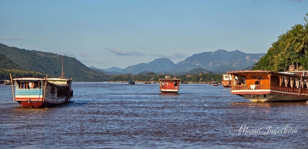 Boats for local transportation and a ride to enjoy scenic sunsets on the Mekong River in Luang Prabang