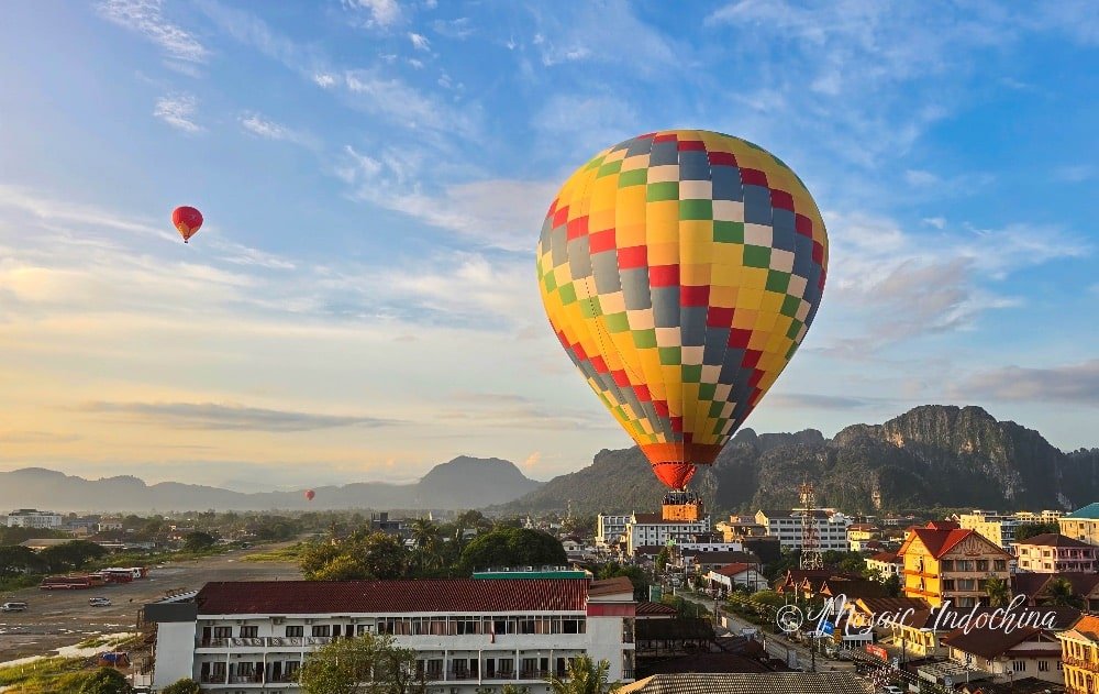 Scenic hot air balloon ride over Vang Vieng, its lush green environment and towering mountains