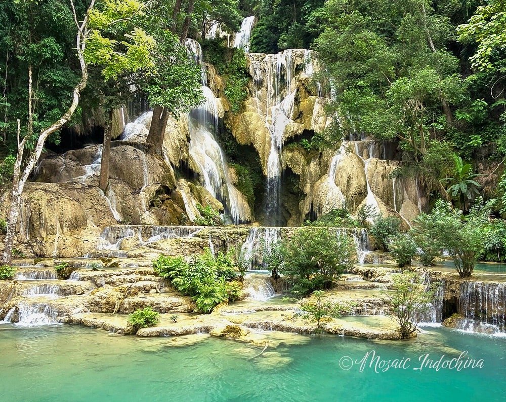 Scenic Kuang Si Waterfalls in Luang Prabang, a popular natural attraction in Laos with vivid blue lagoons and serene beauty