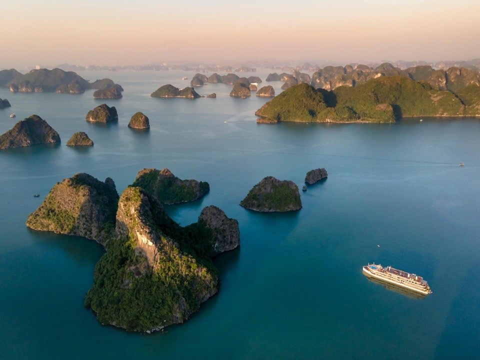 Ha Long Bay cruise tour with turquoise waters and limestone islands